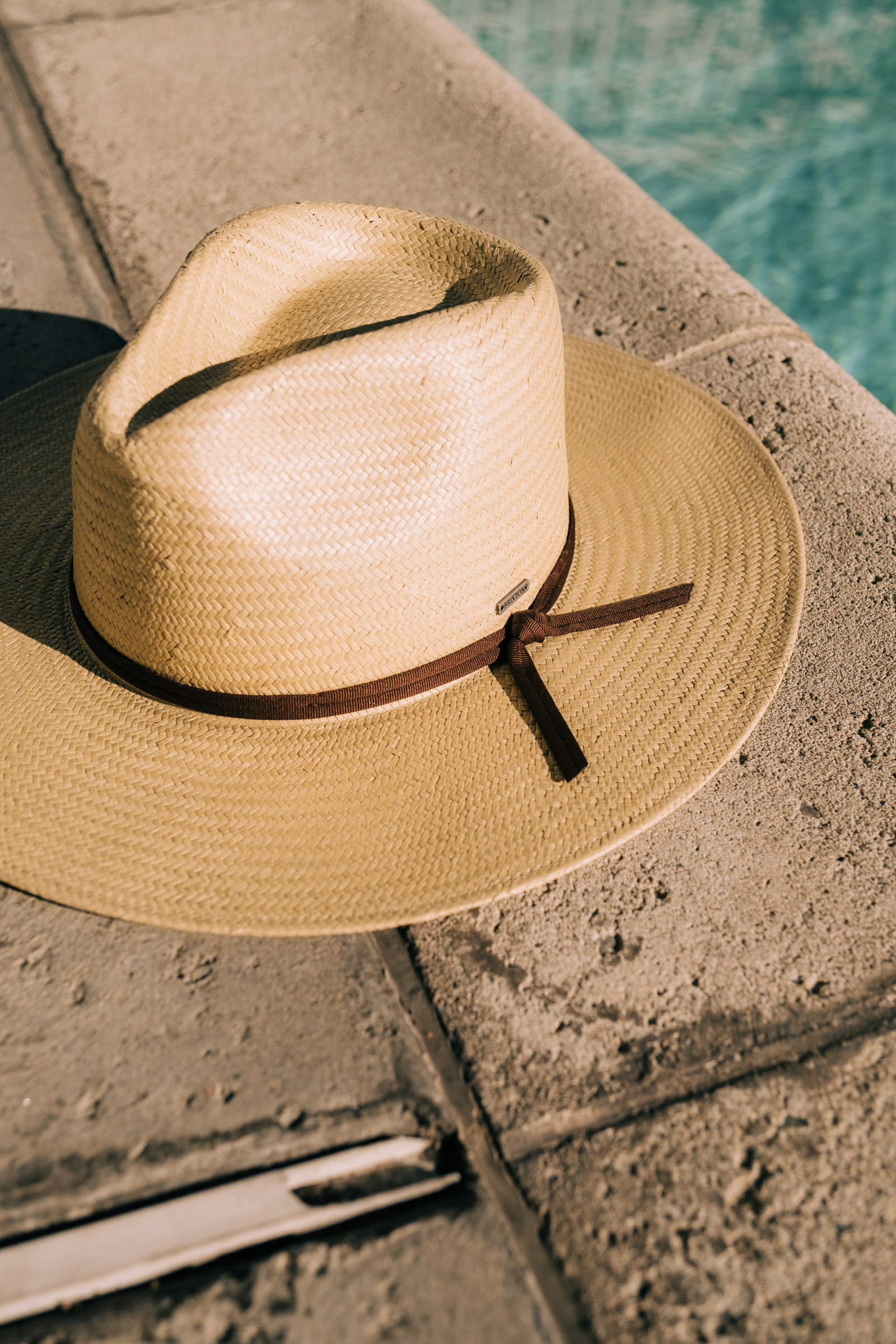 Brixton hat by the pool