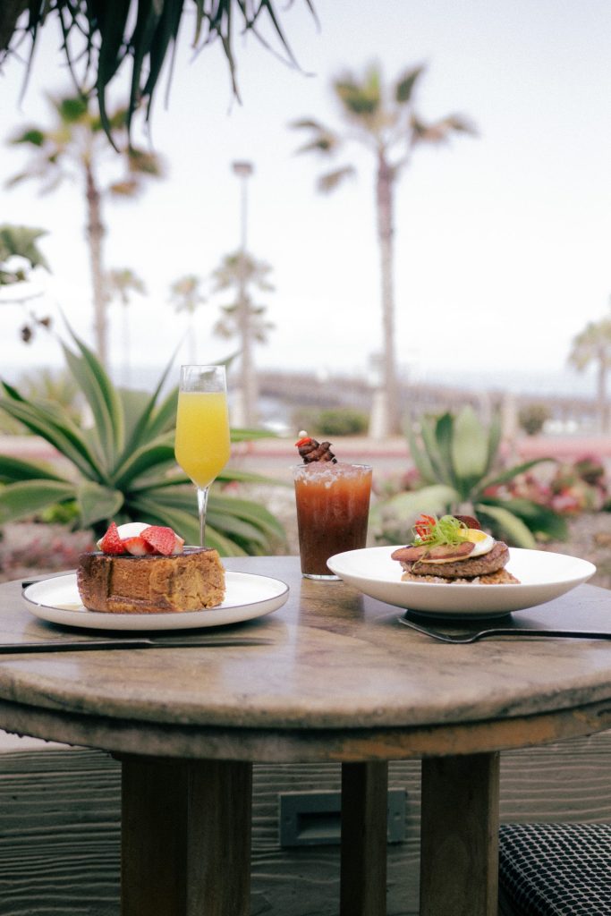 a delectable brunch at the cafe showing an oceanfront view of oceanside's beach and historic oceanside pier