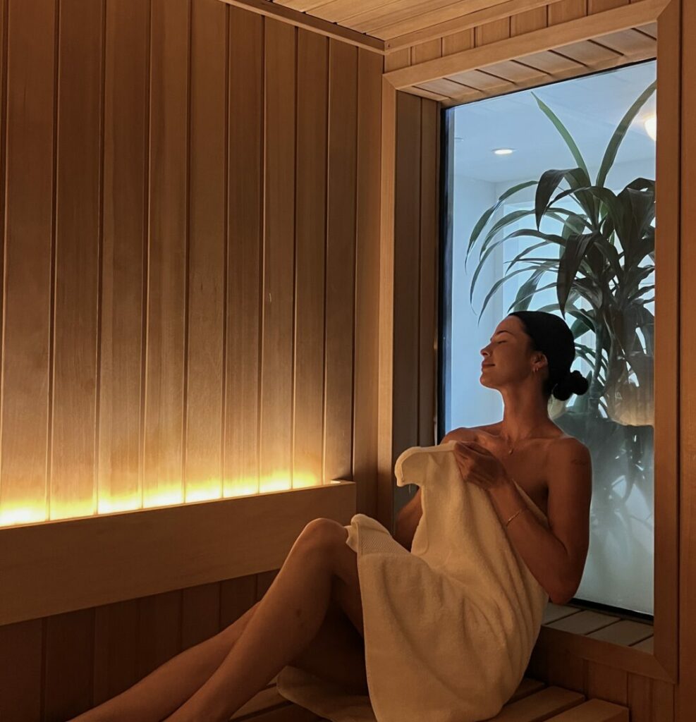 Woman relaxing in a sauna at sunny spa & beauty lounge