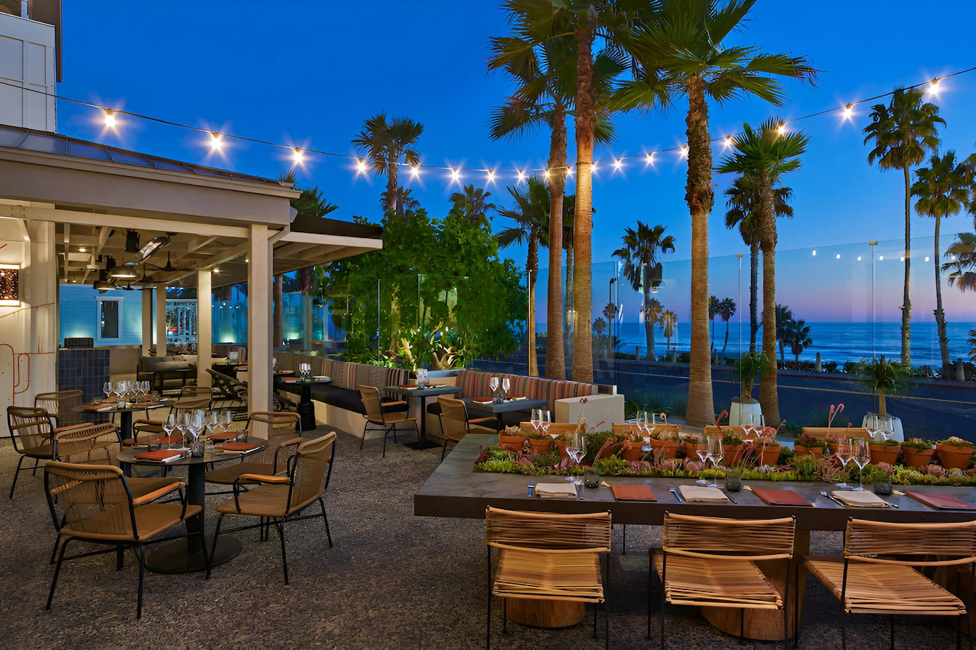 Luxurious terrace of Valle restaurant at dusk overlooking the beach