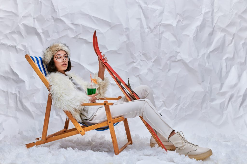 Girl in beach chair and skis