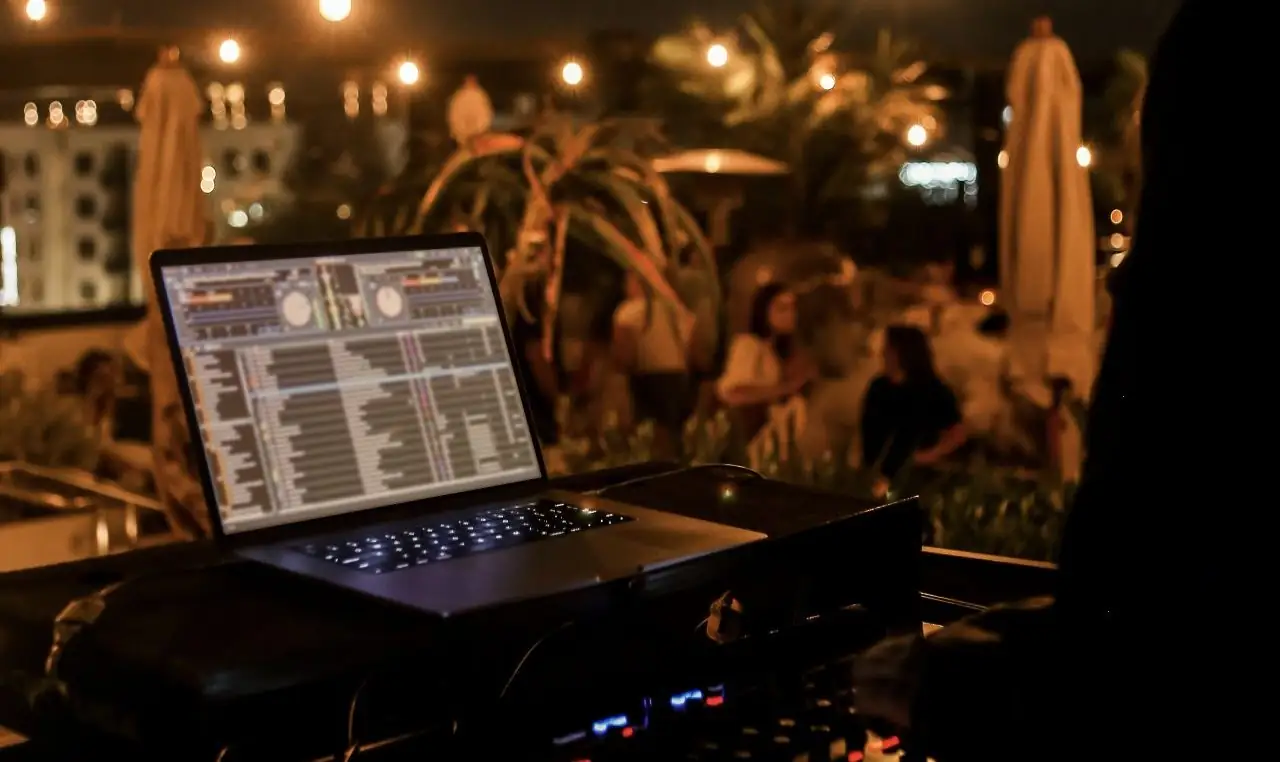 Nighttime dj booth at the rooftop bar, mission pacific hotel, with ambient lighting and ocean breeze vibes.