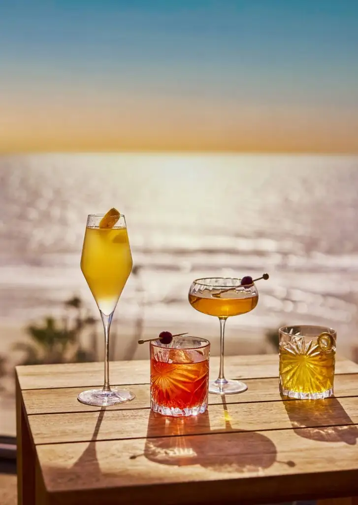 Colorful cocktails on a table overlooking the ocean at Mission Pacific Hotel.