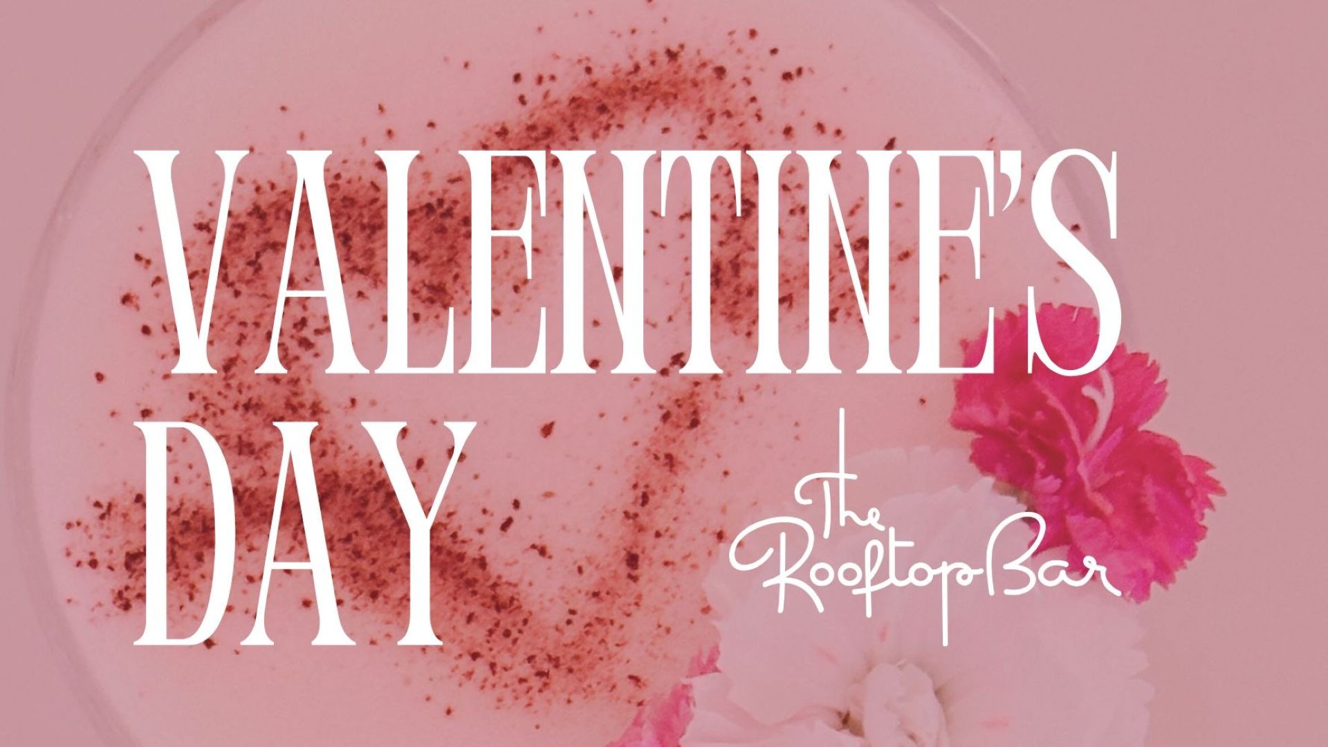 Pink Valentine’s Day drink with flowers in the background and text promoting The Rooftop Bar
