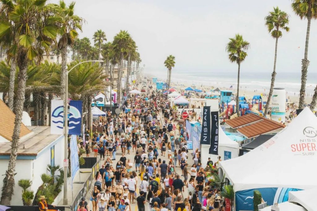 Aerial view of the crowd on oceanside beach during the supergirl surf festival